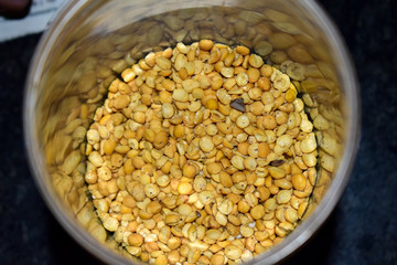 Split pulses in huge number kept in a bottle which gives the reflection of yellow pulses