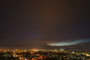 Dramatic sunset sky and clouds moving over the mountain and city, Chiang Mai in Thailand..