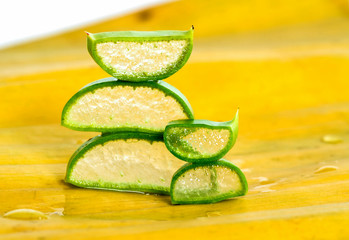 Fresh aloe vera sliced on banana leaf background