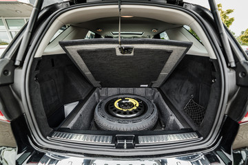 a reserve wheel of a modern german car in the trunk