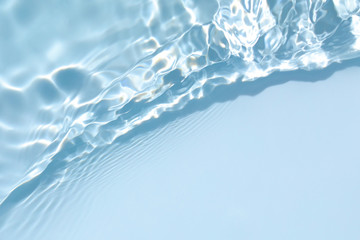 Blurred transparent blue colored clear calm water surface texture with splashes and bubbles. Trendy...