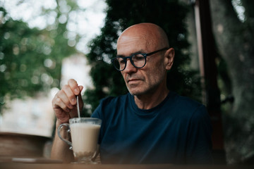 a business man sitting on the street drinking coffee