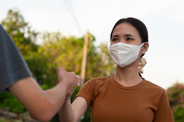 Asian man and women shake hand no touching to protect corona virus concept new normal social...