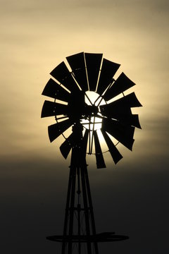 Windmill silhouette at sunset in Kansas north of Hutchinson Kansas USA.