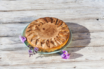 Piece of homemade apple pie with flowers