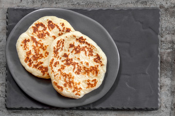 Flat Bread on Gray Plate over Slate Top View
