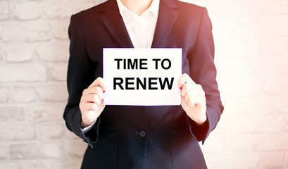 woman showing white card with TIME TO RENEW word . Business