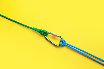 Ropes with lobster clasp on color background
