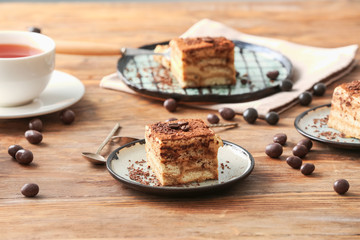 Plate with tasty tiramisu on table