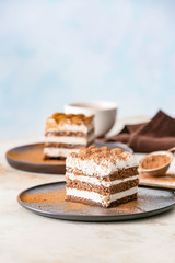 Plate with tasty tiramisu on table