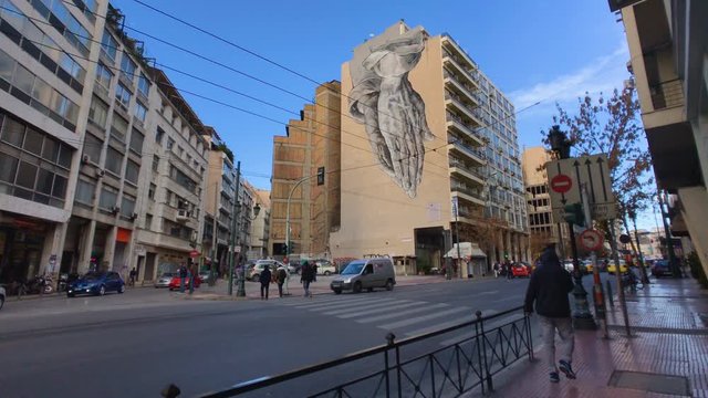 Hands mural on building wall in Athens, Greece