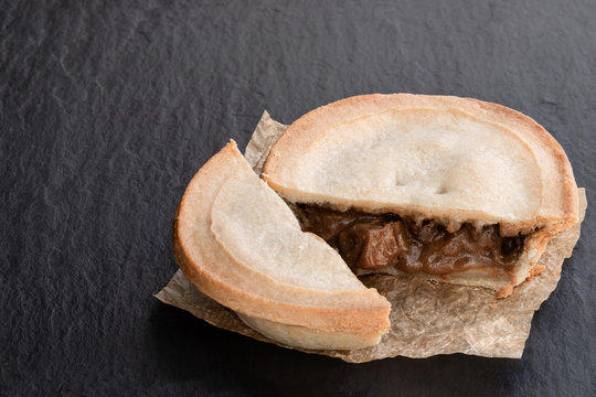 Pukka pie pasty on black stone background