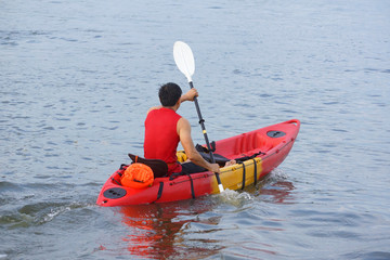 Man rowing a kayak boat in the river