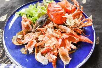 food waste plate with shellfish / Plate after eating seafood lobster shellfish shrimp - dirty dishes