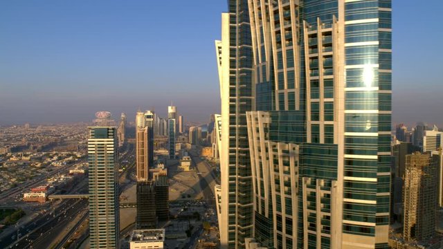 Parallax effect looking at the Burj Khalifa while coming from behind JW Marriott Marquis Hotel and dolling left, 6-axis stabilized gimbal, Shotover F1, 8K, parallax.