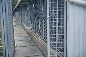 Locked cages for storage with grassy sidewalk