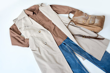 outfir for autumn. women stylish clothes flat lay. beige jacket, blouse and jeans with bag. top view