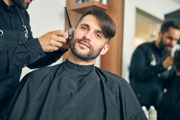 Handsome brunette male person doing beauty procedure
