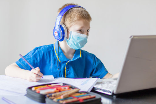 COVID 19 Young bopy studying homework math during her online lesson at home
