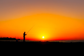 Fototapeta na wymiar fisherman and fishing at sunrise