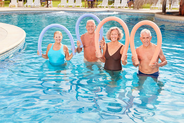 Group of seniors at aquafitness course in the outdoor pool