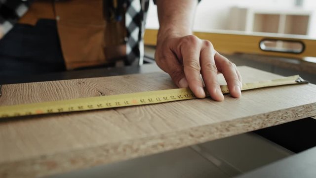 Video of carpenter designing cut lines for boards. Shot with RED helium camera in 8K