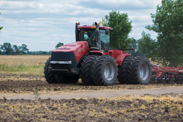 august 2020 ukraine kiev region work in the field big red tractor close up illustrative editorial