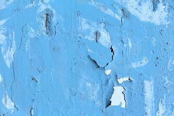 Old wall with peeling blue paint