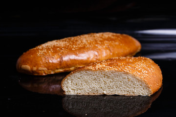 Homemade pastries. Crispy white bread cut with a knife.