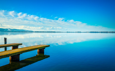 Two piers or jetties, sunset blue panoramic landscape. Orbetello lagoon, Argentario, Italy.
