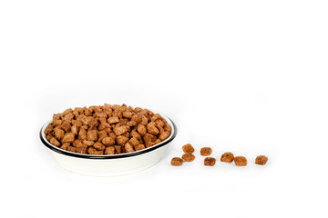 Dry pet food in a white ceramic bowl isolated on white background