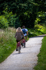 Fototapeta premium couple cycling along dirt track 
