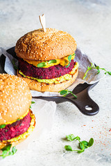 Vegan beetroot burger with sweet potato sauce and guacamole. Plant based diet concept.