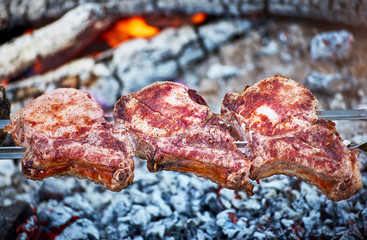 Cooking juicy meat on the grill in the afternoon.