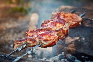 Cooking juicy meat on the grill in the afternoon.