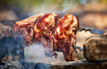 Cooking juicy meat on the grill in the afternoon.