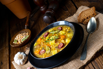 Rustic pea soup with bacon and sausages