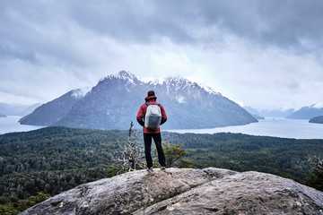 Fototapeta premium Unrecognized man in a mountain looking to the lake landscape