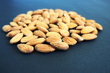 close a lot of almond seeds on a dark background side view