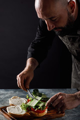 The chef cooks burgers in the restaurant.