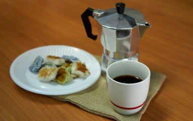 Coffee in a cup with moka pot and Thai desserts on a sack with a