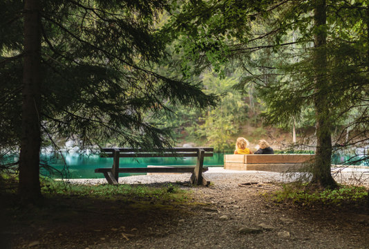 a couple of friends relaxing in front of Lac Vert, in the city of Passy, France