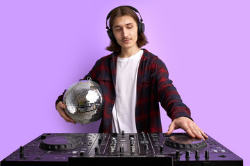 DJ disco icon perform music, holding disco ball in hands. modern stylish guy in headphone enjoy...