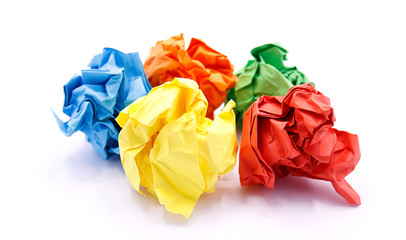 Colored crumpled paper rolled into a ball close-up on a white background
