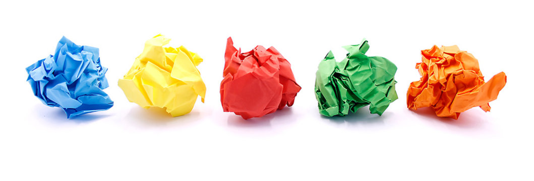 Colored crumpled paper rolled into a ball close-up on a white background