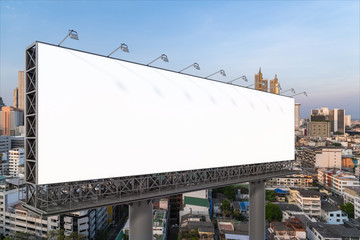 Blank white road billboard with Bangkok cityscape background at sunset. Street advertising poster, mock up, 3D rendering. Side view. The concept of marketing communication to promote or sell idea. © VideoFlow