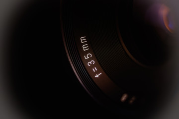 Macro shot of an analog camera lens. Partial view. Abstract dark illustration. 