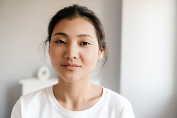 Close up of a smiling young asian woman relaxing