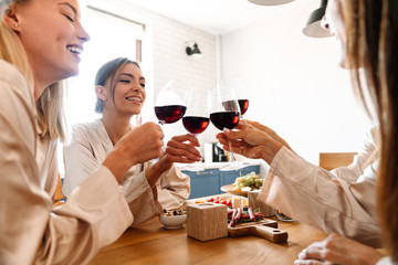 Beautiful cheerful girlfriends in kitchen
