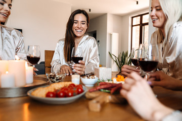 Beautiful cheerful girlfriends in kitchen